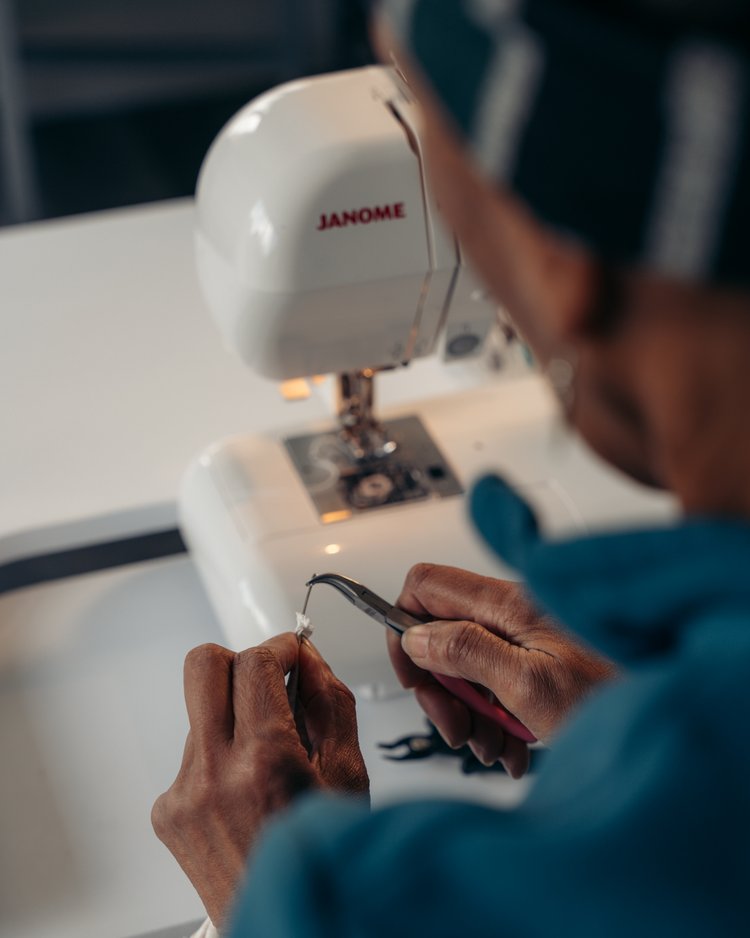 Founder of Advanced Textile Solutions sewing face masks during the pandemic